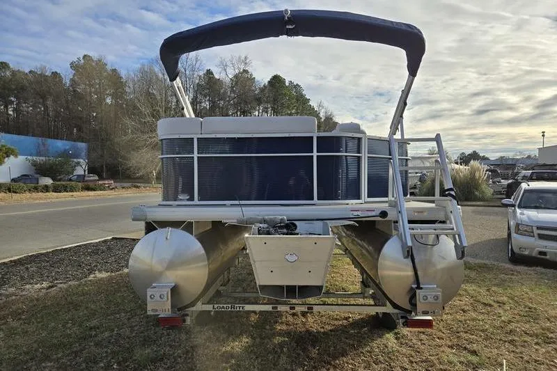 Slide: The Image of 2022 Godfrey Sweetwater 2286 BF pontoon boat on trailer, parked outdoors. - 10