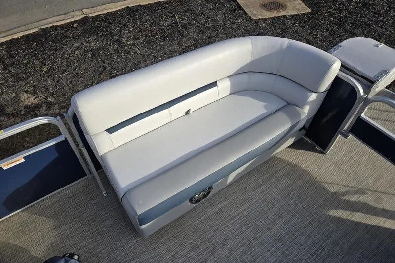 Slide: The Image of 2022 Godfrey Sweetwater 2286 BF boat interior with gray seating and carpeted flooring. - 5