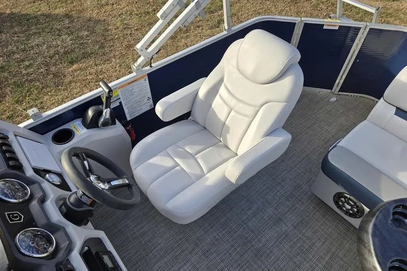 Slide: The Image of 2022 Godfrey Sweetwater 2286 BF boat interior with plush captain's chair and steering console. - 6