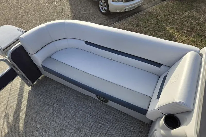 Slide: The Image of 2022 Godfrey Sweetwater 2286 BF boat seating area with plush white upholstery. - 7