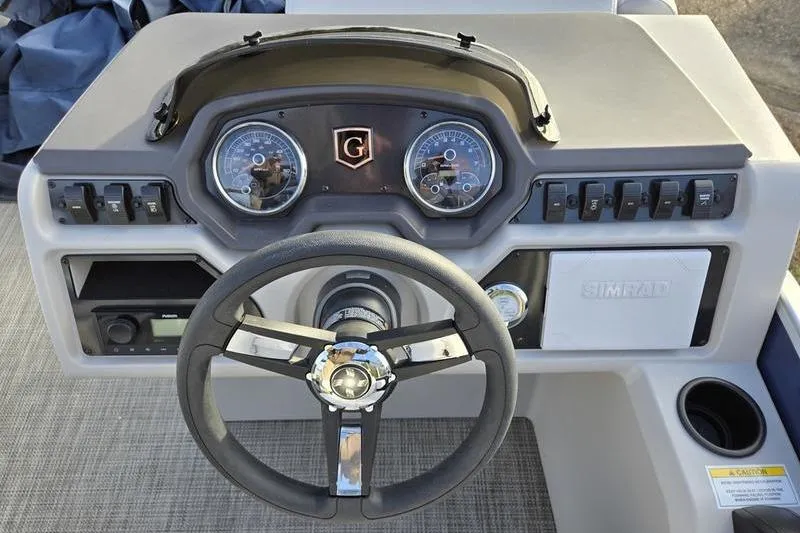 Slide: The Image of 2022 Godfrey Sweetwater 2286 BF boat dashboard with steering wheel and control panel. - 8