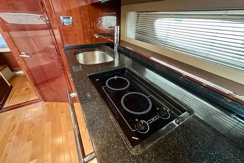 Slide: The Image of Luxurious 2011 Sea Ray 450 Sundancer yacht kitchen with sleek countertops and modern appliances. - 10