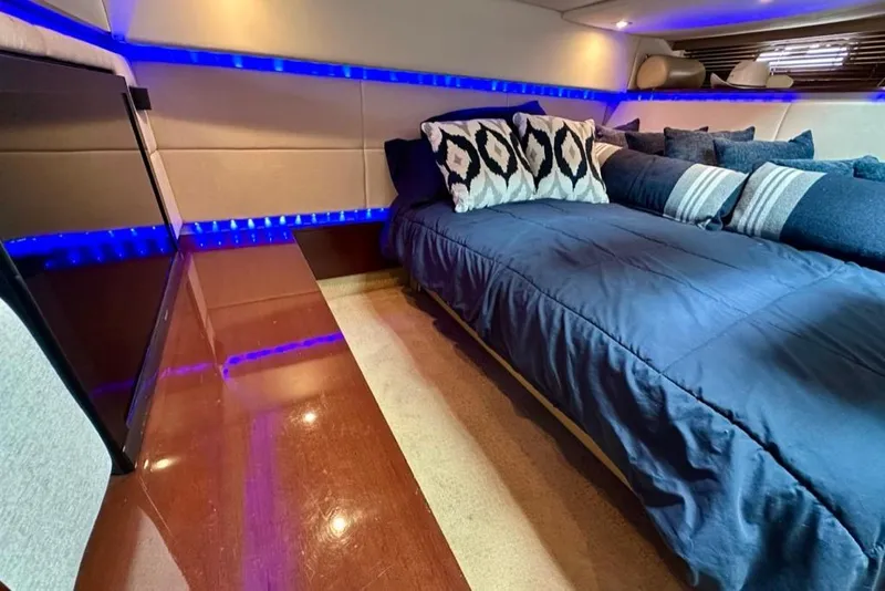 Slide: The Image of Luxurious interior cabin of 2011 Sea Ray 450 Sundancer with blue LED lighting. - 19