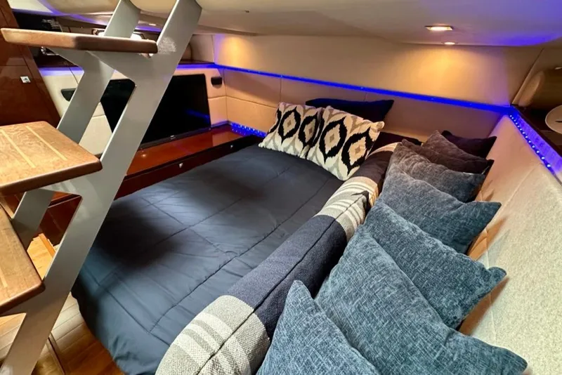 Slide: The Image of Luxurious cabin interior of 2011 Sea Ray 450 Sundancer with cozy bedding and ambient lighting. - 21