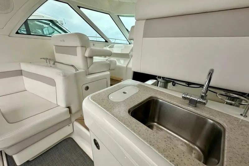 Slide: The Image of Interior of 2011 Sea Ray 450 Sundancer yacht with seating and sink area. - 22