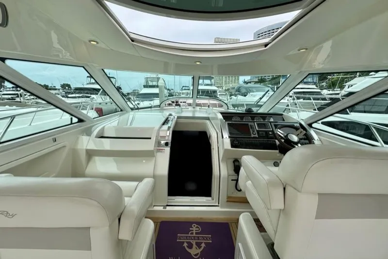 Slide: The Image of Interior view of 2011 Sea Ray 450 Sundancer yacht cockpit with luxurious seating and controls. - 23