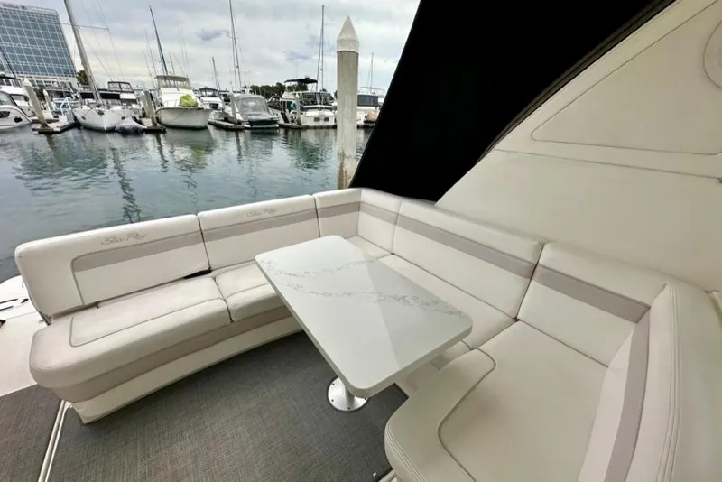 Slide: The Image of Luxurious seating area on a 2011 Sea Ray 450 Sundancer yacht, docked at a marina. - 25