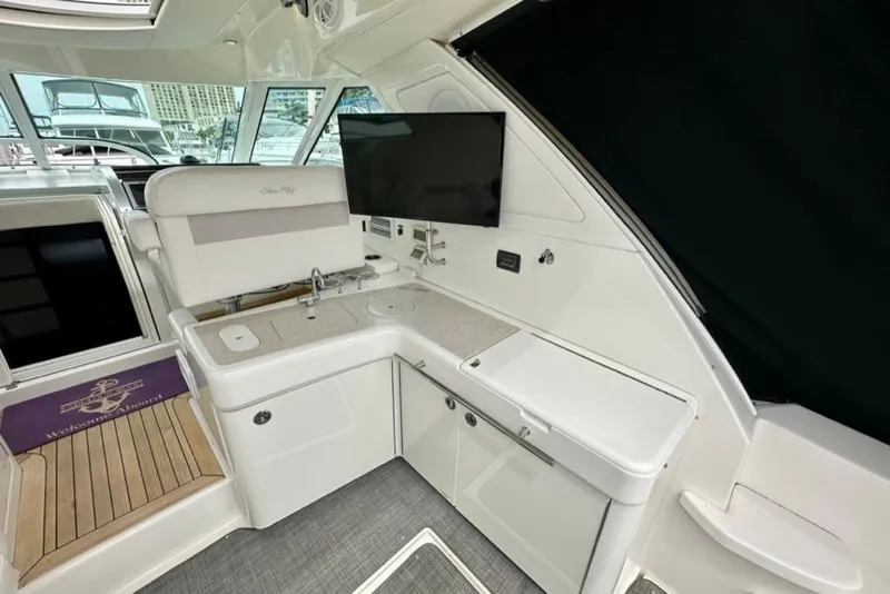 Slide: The Image of Interior of 2011 Sea Ray 450 Sundancer yacht with kitchenette and seating area. - 30