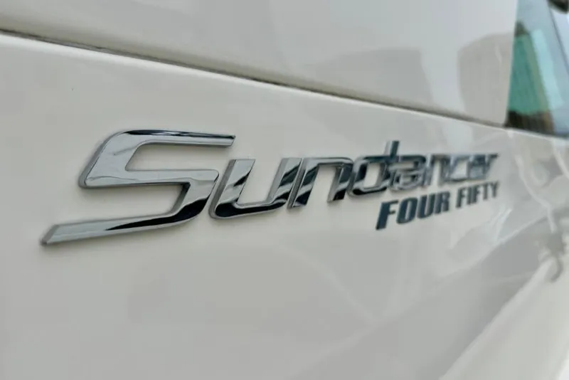 Slide: The Image of Close-up of 2011 Sea Ray 450 Sundancer logo on white surface. - 40