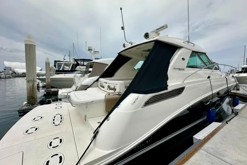 Slide: The Image of 2011 Sea Ray 450 Sundancer yacht docked at marina, featuring sleek design and modern amenities. - 42