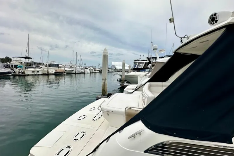 Slide: The Image of 2011 Sea Ray 450 Sundancer docked in a marina with other boats. - 44
