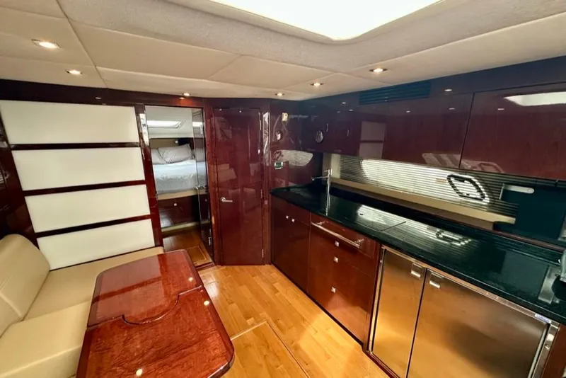 Slide: The Image of Luxurious interior of 2011 Sea Ray 450 Sundancer yacht with modern kitchen and seating area. - 8