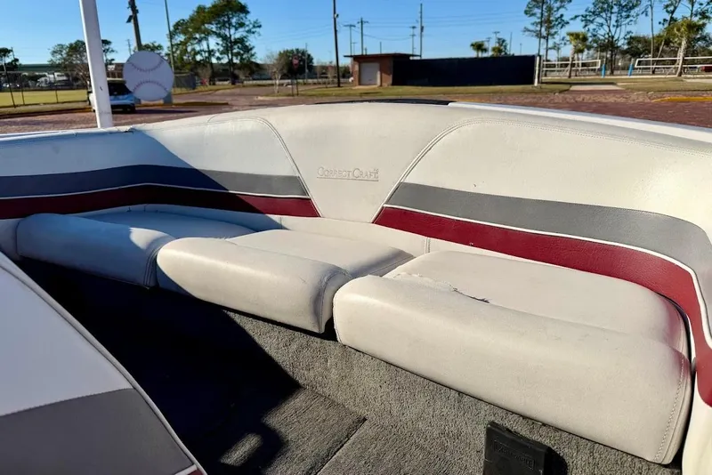 Slide: The Image of 1993 Correct Craft Sport Nautique boat interior with white, gray, and red seating. - 10