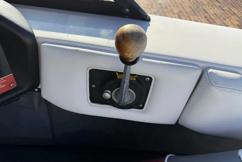 Slide: The Image of 1993 Correct Craft Sport Nautique throttle lever on boat dashboard. - 19