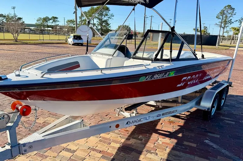 Slide: The Image of 1993 Correct Craft Sport Nautique boat on trailer, red and white design, parked outdoors. - 4