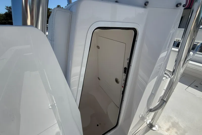 Slide: The Image of 2026 Contender 25 Tournament boat interior compartment with open door, showcasing sleek design. - 11
