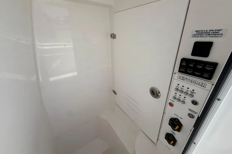 Slide: The Image of Interior control panel of 2026 Contender 25 Tournament boat, featuring various switches and labels. - 12