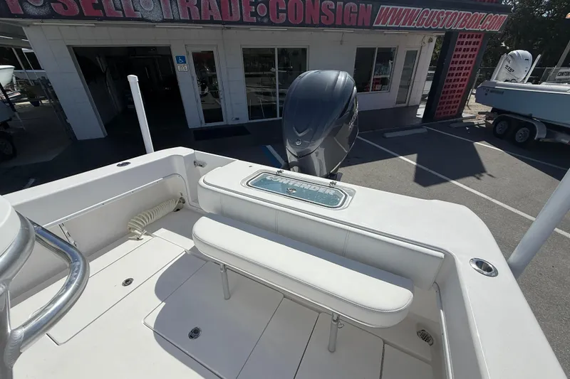 Slide: The Image of 2026 Contender 25 Tournament boat with outboard motor at dealership. - 14