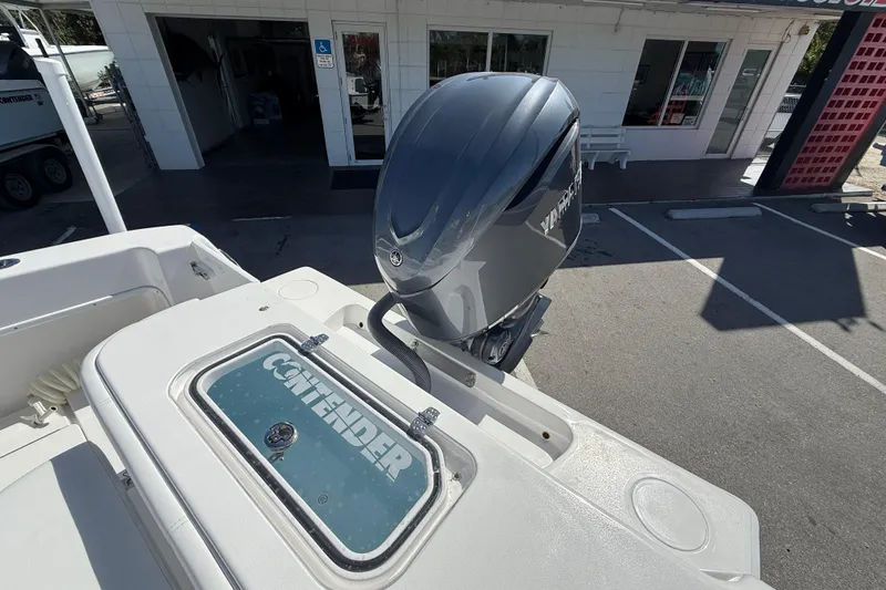 Slide: The Image of 2026 Contender 25 Tournament boat with Yamaha outboard motor in a parking lot. - 15
