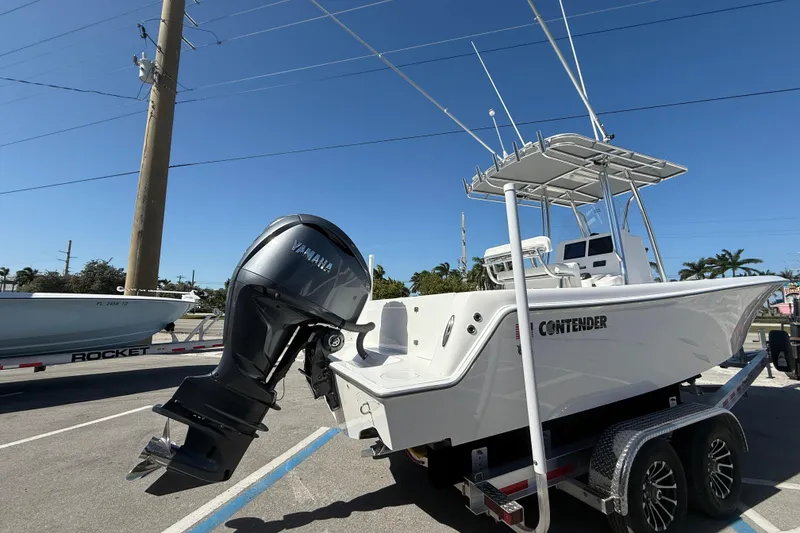 Slide: The Image of 2026 Contender 25 Tournament boat with Yamaha outboard engine on trailer. - 2
