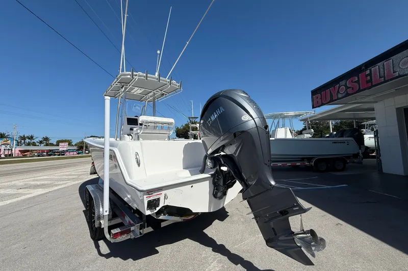 Slide: The Image of 2026 Contender 25 Tournament boat with Yamaha outboard motor, parked near dealership. - 3