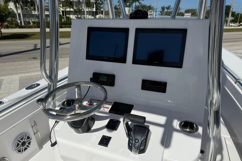 Slide: The Image of 2026 Contender 25 Tournament boat dashboard with dual screens and steering wheel. - 5