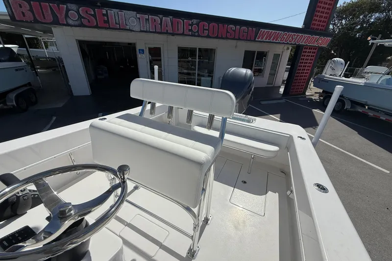Slide: The Image of 2026 Contender 25 Tournament boat at dealership, showcasing helm and seating area. - 7