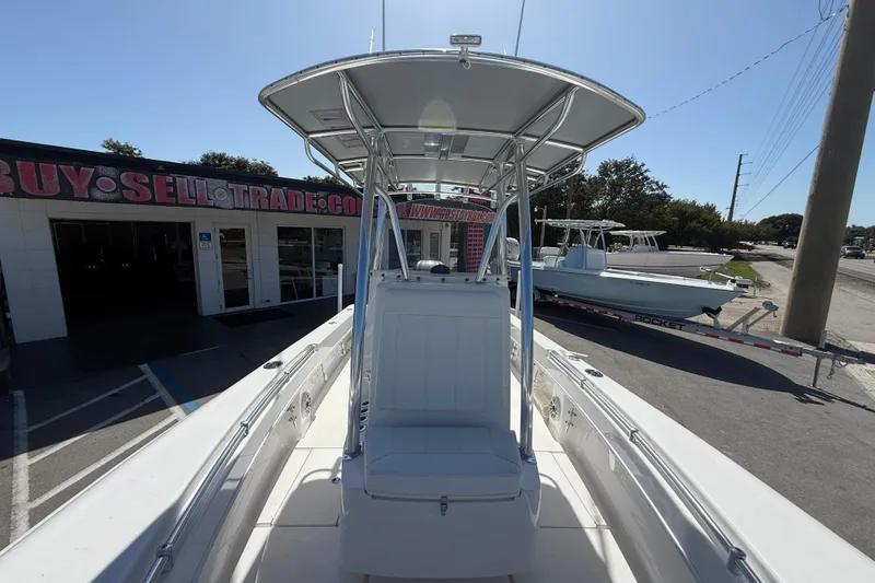 Slide: The Image of 2026 Contender 25 Tournament boat displayed at dealership, showcasing sleek design and T-top. - 8