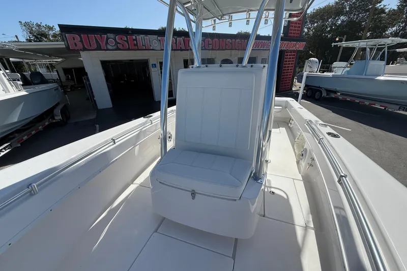 Slide: The Image of 2026 Contender 25 Tournament boat interior with seating and console, displayed outdoors. - 9