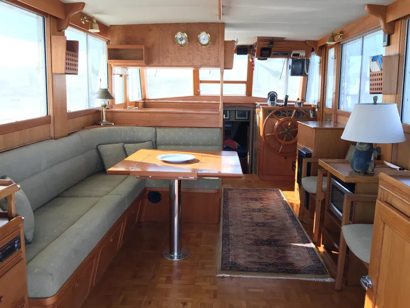 Slide: The Image of Interior of a 1982 Grand Banks 42 Europa yacht, featuring wood furnishings and helm. - 10
