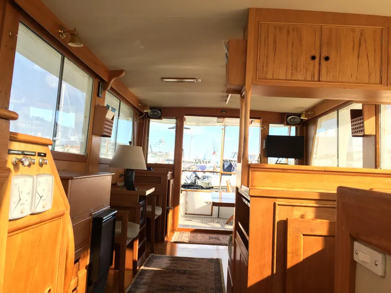 Slide: The Image of Interior of a 1982 Grand Banks 42 Europa yacht, featuring wooden furnishings. - 11
