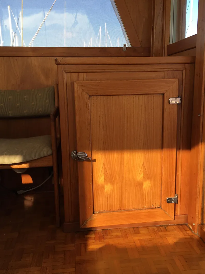 Slide: The Image of Wooden cabinet inside a 1982 Grand Banks 42 Europa. - 32