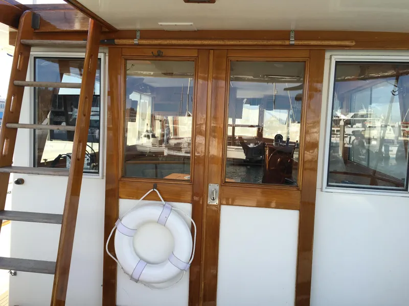 Slide: The Image of Wooden doors and lifebuoy on 1982 Grand Banks 42 Europa. - 4