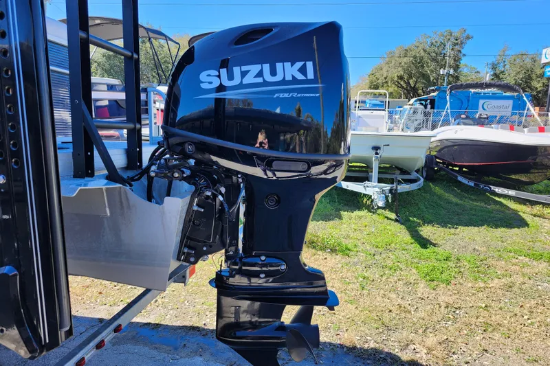 Slide: The Image of 2022 Godfrey Sweetwater 2286 SFL with Suzuki outboard motor in a boatyard setting. - 10