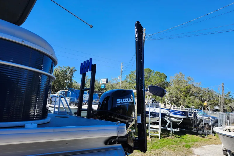 Slide: The Image of 2022 Godfrey Sweetwater 2286 SFL boat with Suzuki motor in a marina setting. - 11