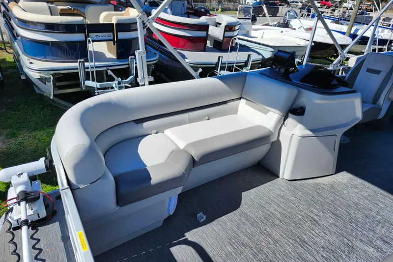 Slide: The Image of 2022 Godfrey Sweetwater 2286 SFL pontoon boat interior with plush seating and control console. - 15
