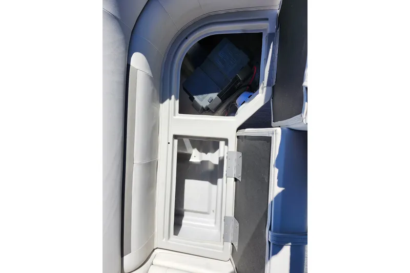 Slide: The Image of Open storage compartment on 2022 Godfrey Sweetwater 2286 SFL boat. - 17