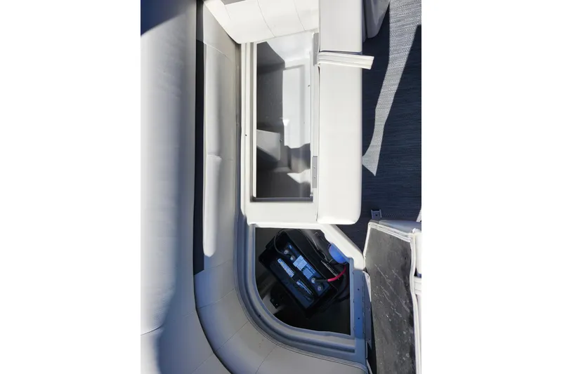 Slide: The Image of 2022 Godfrey Sweetwater 2286 SFL boat interior with storage compartment and battery. - 18