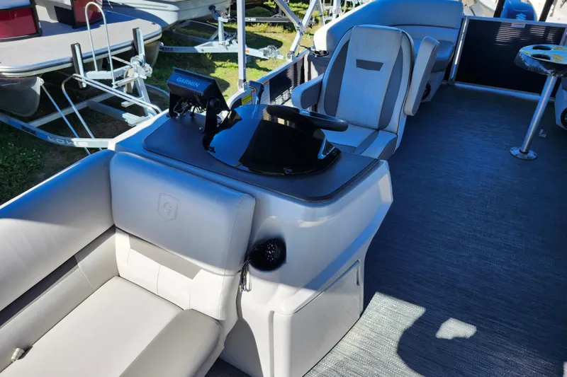 Slide: The Image of 2022 Godfrey Sweetwater 2286 SFL boat interior with modern seating and navigation equipment. - 19