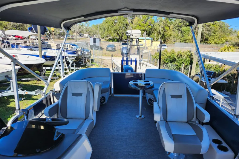 Slide: The Image of 2022 Godfrey Sweetwater 2286 SFL pontoon boat interior with seating and canopy. - 21
