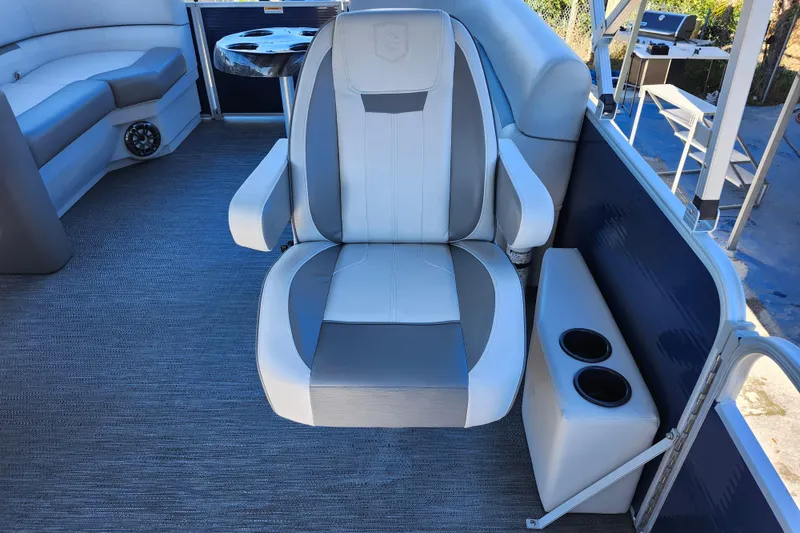 Slide: The Image of Captain's chair on 2022 Godfrey Sweetwater 2286 SFL pontoon boat with cup holders. - 22