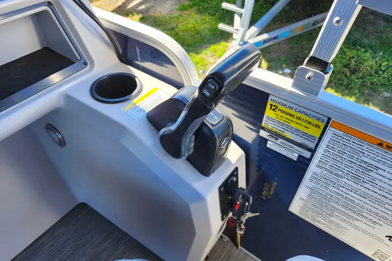 Slide: The Image of Control panel of 2022 Godfrey Sweetwater 2286 SFL boat with throttle and capacity label. - 26