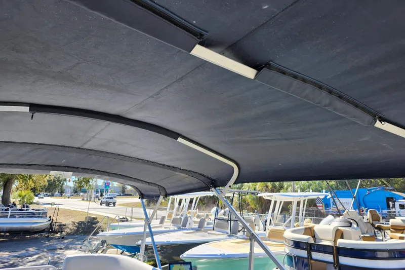 Slide: The Image of 2022 Godfrey Sweetwater 2286 SFL pontoon boat with canopy, docked in a marina. - 39