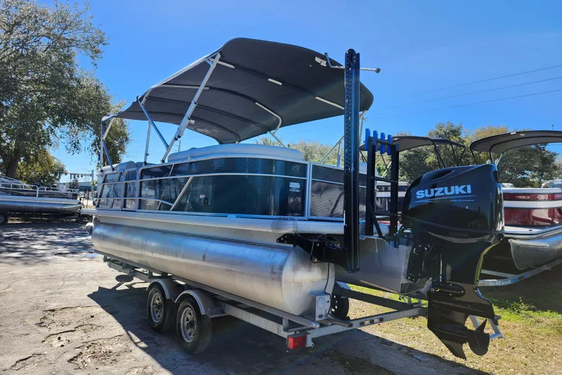Slide: The Image of 2022 Godfrey Sweetwater 2286 SFL pontoon boat with Suzuki outboard motor on trailer. - 5