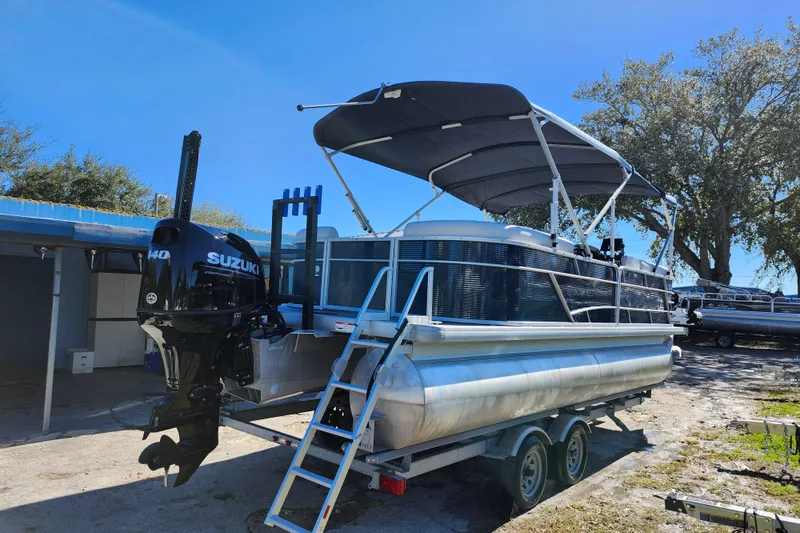 Slide: The Image of 2022 Godfrey Sweetwater 2286 SFL pontoon boat with Suzuki engine on trailer. - 7