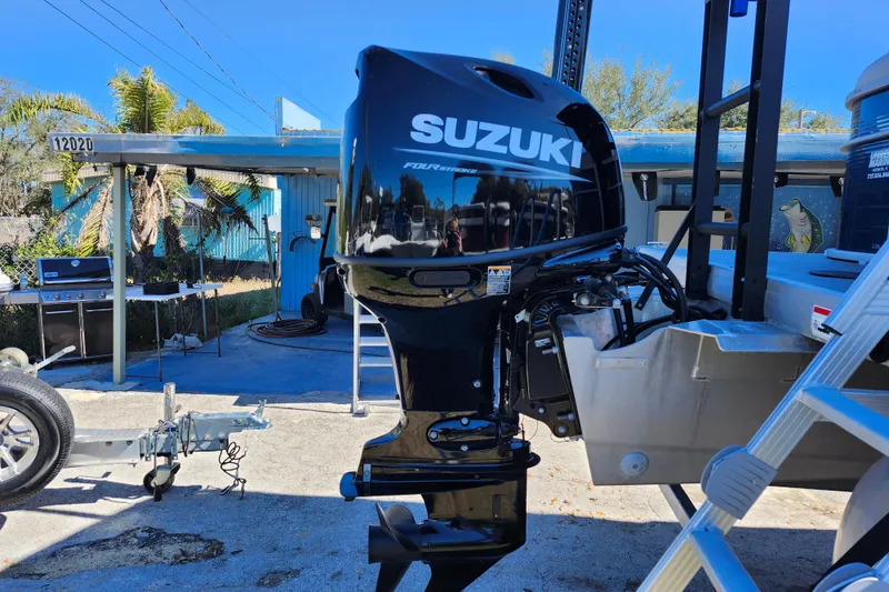 Slide: The Image of 2022 Godfrey Sweetwater 2286 SFL with Suzuki outboard motor in a sunny outdoor setting. - 9