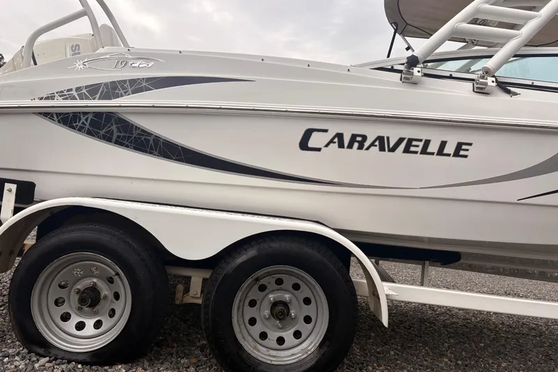 Slide: The Image of 2020 Caravelle 19 EBo Fish & Ski boat on trailer, side view. - 11