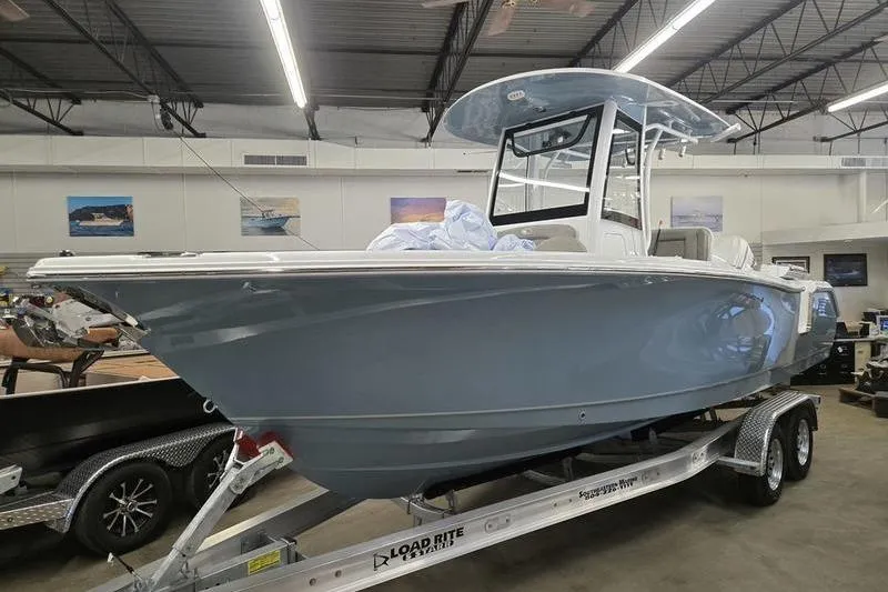 The Image of 2025 Sea Hunt Ultra 255 SE boat on trailer in showroom. - 0