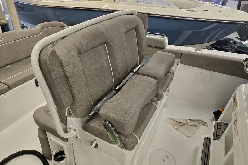 Slide: The Image of 2025 Sea Hunt Ultra 255 SE boat interior with cushioned seating. - 2