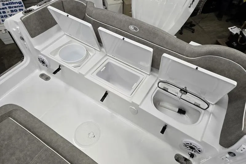 Slide: The Image of 2025 Sea Hunt Ultra 255 SE boat interior with open storage compartments and seating. - 5